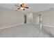 Spacious living area with white tile flooring, ceiling fan, and ample natural light at 557 Hunter Cir, Kissimmee, FL 34758