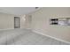 Open-concept living room with tile floors next to kitchen featuring stainless steel appliances at 557 Hunter Cir, Kissimmee, FL 34758
