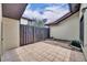 Enclosed patio with patterned tile, a privacy fence, and some landscaping at 557 Hunter Cir, Kissimmee, FL 34758