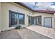 Private patio with neutral stucco walls, a tile patio area, and sliding glass doors at 557 Hunter Cir, Kissimmee, FL 34758