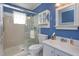Well-lit bathroom with a glass shower, a toilet, and a white vanity with ample storage at 5654 Minute Man Ct, Orlando, FL 32821