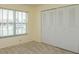 Bedroom featuring a large closet, neutral carpet, and a window providing natural light at 5654 Minute Man Ct, Orlando, FL 32821