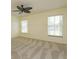 Neutral bedroom includes carpet flooring and large windows allowing natural light at 5654 Minute Man Ct, Orlando, FL 32821