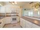 Well-lit kitchen features white cabinetry, tile floor and eat in bar at 5654 Minute Man Ct, Orlando, FL 32821