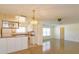 Bright kitchen and open living area with tiled floors, white cabinets, and a breakfast bar at 5654 Minute Man Ct, Orlando, FL 32821