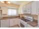 Modern kitchen with white cabinets, tiled floors, and updated appliances at 5654 Minute Man Ct, Orlando, FL 32821