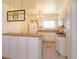 Well-lit kitchen featuring white cabinetry, tiled floors, and an open design at 5654 Minute Man Ct, Orlando, FL 32821