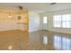 Spacious living and dining area with tile flooring, wainscoting, and ample natural light from the large window at 5654 Minute Man Ct, Orlando, FL 32821