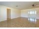 Open living area with tile floors, neutral walls, and views into other rooms, creating an airy feel at 5654 Minute Man Ct, Orlando, FL 32821