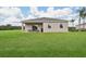 Enjoy the expansive backyard featuring a covered patio, perfect for relaxation and entertaining at 5909 Cliffbow Loop, Leesburg, FL 34748