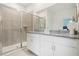 Bathroom showcases a double vanity, granite countertop, tiled shower with glass door, and neutral color scheme at 5909 Cliffbow Loop, Leesburg, FL 34748