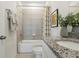 Bright bathroom with granite counters, decorative shower curtain and modern fixtures at 5909 Cliffbow Loop, Leesburg, FL 34748