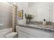 Well-lit bathroom features granite counters, decorative shower curtain and modern fixtures at 5909 Cliffbow Loop, Leesburg, FL 34748