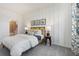 Well-lit bedroom featuring a comfortable bed, stylish decor, and an ensuite bathroom at 5909 Cliffbow Loop, Leesburg, FL 34748
