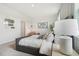 Bright bedroom featuring stylish decor, a comfortable gray bed, and modern wall art at 5909 Cliffbow Loop, Leesburg, FL 34748