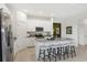 Modern kitchen with a central island, stainless steel appliances, granite countertops, and seating for casual dining at 5909 Cliffbow Loop, Leesburg, FL 34748
