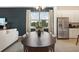 Comfortable open living area with a large dining table, stainless steel appliances, and a modern design at 5909 Cliffbow Loop, Leesburg, FL 34748