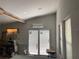 Bright living area with shiplap walls, large windows, and a sliding glass door to the outside at 63 Lake Wood Cir, Ocala, FL 34482