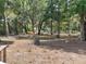 Lush yard filled with mature trees, offering ample shade and natural beauty to the property at 63 Lake Wood Cir, Ocala, FL 34482