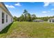 Spacious backyard featuring grass, mature trees, and a shed at 6765 152Nd Lane Rd, Ocala, FL 34473