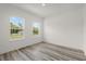 Bright bedroom featuring luxury vinyl plank flooring and two windows at 6765 152Nd Lane Rd, Ocala, FL 34473