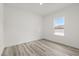 Bright bedroom featuring luxury vinyl plank flooring and a window at 6765 152Nd Lane Rd, Ocala, FL 34473