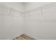Walk-in closet with white walls, wood-look floors and wire shelving at 6765 152Nd Lane Rd, Ocala, FL 34473