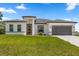Charming single-story home featuring a well-manicured lawn, neutral paint, and inviting curb appeal at 6765 152Nd Lane Rd, Ocala, FL 34473