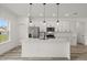 Modern kitchen featuring stainless steel appliances, an island with pendant lighting, and ample counter space at 6765 152Nd Lane Rd, Ocala, FL 34473