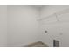 Clean and simple laundry area with utility sink and shelving at 6765 152Nd Lane Rd, Ocala, FL 34473