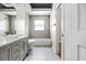 Modern bathroom showcasing stylish gray tiling, a shower/tub combo, and contemporary vanity at 707 Heritage Ne Dr, Winter Haven, FL 33881