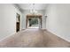 Spacious dining area with chandelier, carpet floors, and views of the lanai at 707 Heritage Ne Dr, Winter Haven, FL 33881