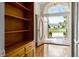 Foyer with front door and built-in shelves at 707 Heritage Ne Dr, Winter Haven, FL 33881