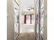 Hallway view towards living room, highlighting the layout and flow of the home with stylish mirrored doors at 707 Heritage Ne Dr, Winter Haven, FL 33881