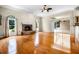 Spacious living room with hardwood floors, stone fireplace, and sliding glass doors to the lanai at 707 Heritage Ne Dr, Winter Haven, FL 33881