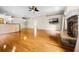 Open-concept living area with hardwood floors, stone fireplace, and bar counter at 707 Heritage Ne Dr, Winter Haven, FL 33881