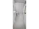 Bright bathroom with shower and white tile at 7220 Westpointe Blvd # 1429, Orlando, FL 32835
