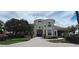 Elegant clubhouse exterior with stucco walls, arched windows, and brick-paved driveway at 7220 Westpointe Blvd # 1429, Orlando, FL 32835