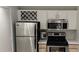 Well-appointed kitchen with stainless steel refrigerator and microwave, and white cabinets and countertops at 7220 Westpointe Blvd # 1429, Orlando, FL 32835