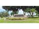 Community entrance sign for Bermuda Dunes Luxury Condominiums amidst lush landscaping at 7220 Westpointe Blvd # 1429, Orlando, FL 32835