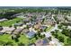 A lovely, two-story home highlighted from an aerial view within a lush, planned community at 7409 Fairgrove Ave, Windermere, FL 34786