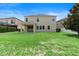Spacious backyard with lush green grass and covered patio at 7409 Fairgrove Ave, Windermere, FL 34786