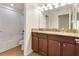 Bathroom featuring double sinks, granite countertops, and a shower-tub combination at 7409 Fairgrove Ave, Windermere, FL 34786