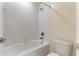 Functional bathroom featuring a bathtub with white tile surround and modern fixtures at 7409 Fairgrove Ave, Windermere, FL 34786