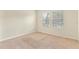 Bright bedroom featuring two windows and neutral carpet at 7409 Fairgrove Ave, Windermere, FL 34786