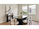 Elegant dining room with modern decor and an abundance of natural light, showcasing a sleek table and stylish chairs at 7409 Fairgrove Ave, Windermere, FL 34786