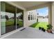Covered patio featuring potted plants and sliding glass doors at 7409 Fairgrove Ave, Windermere, FL 34786