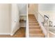 Carpeted staircase with white railing, complemented by a storage nook and tile flooring at 7409 Fairgrove Ave, Windermere, FL 34786