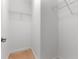 A simple, well-organized walk-in closet with ample shelving for storage at 7409 Fairgrove Ave, Windermere, FL 34786