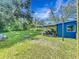 Expansive backyard with a covered patio, providing a serene outdoor living space surrounded by lush greenery at 91 High St, Winter Haven, FL 33880